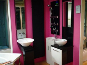 Two sinks placed on wall mounting with dark pink background